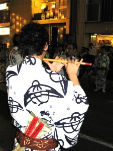 A musician adds to the atmosphere of the Gion Matsuri in Kyoto