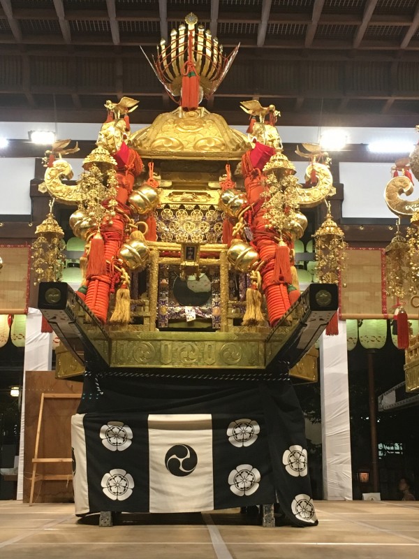 A divine container for a divine spirit, the gold of the mikoshi considered to have a purifying effect and the phoenix on top a Chinese symbol of social harmony