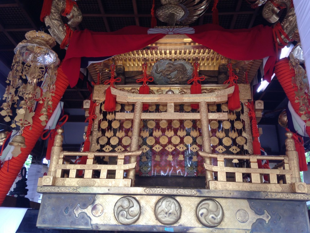 The gorgeous mikoshi contrast with the run-down condition of the shrine.