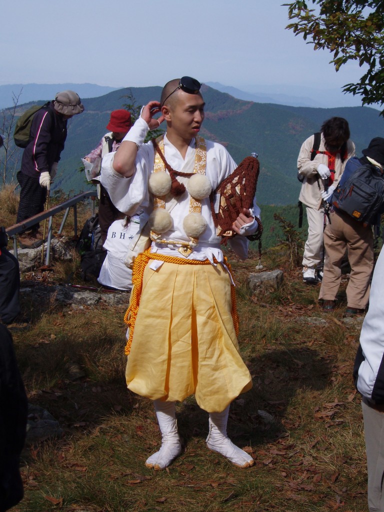 A yamabushi in typical clothing leads a hiking group into the Yoshino hills