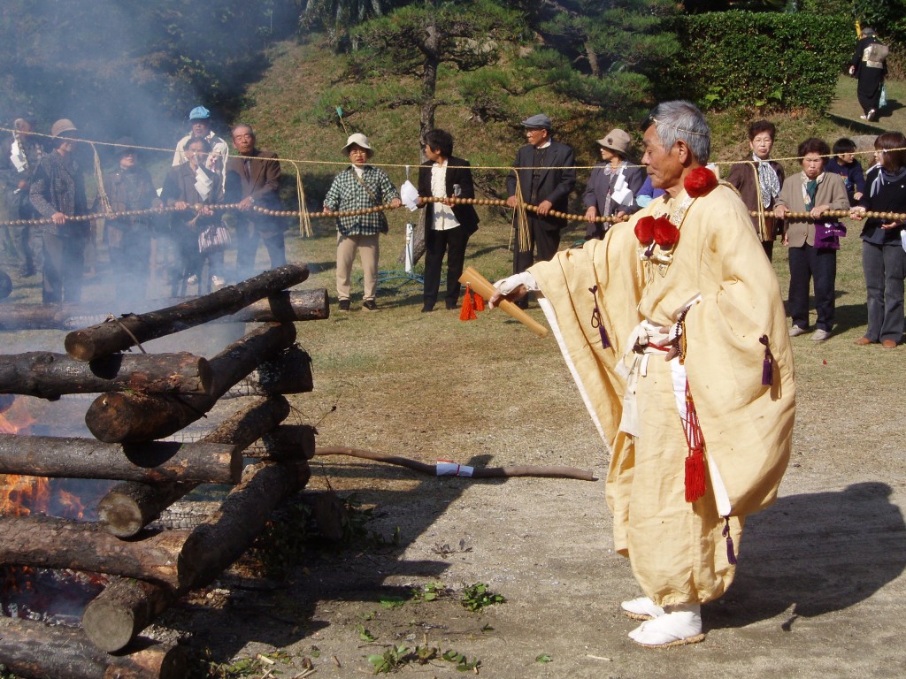 A Yamabushi (mountain ascetic) conducts a fire rite in which wooden prayer tablets are borne on the smoke up to heaven