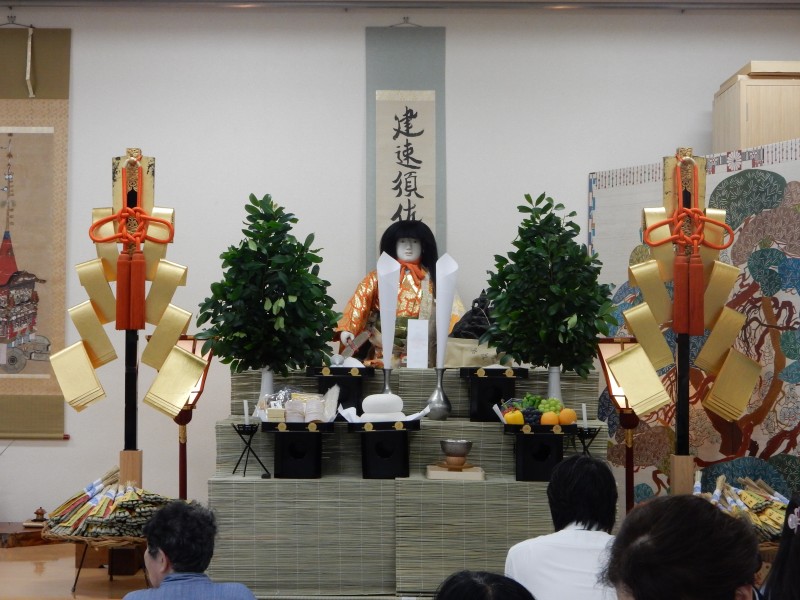 Tea is drunk in front of the altar with the Chrysanthemum Boy doll