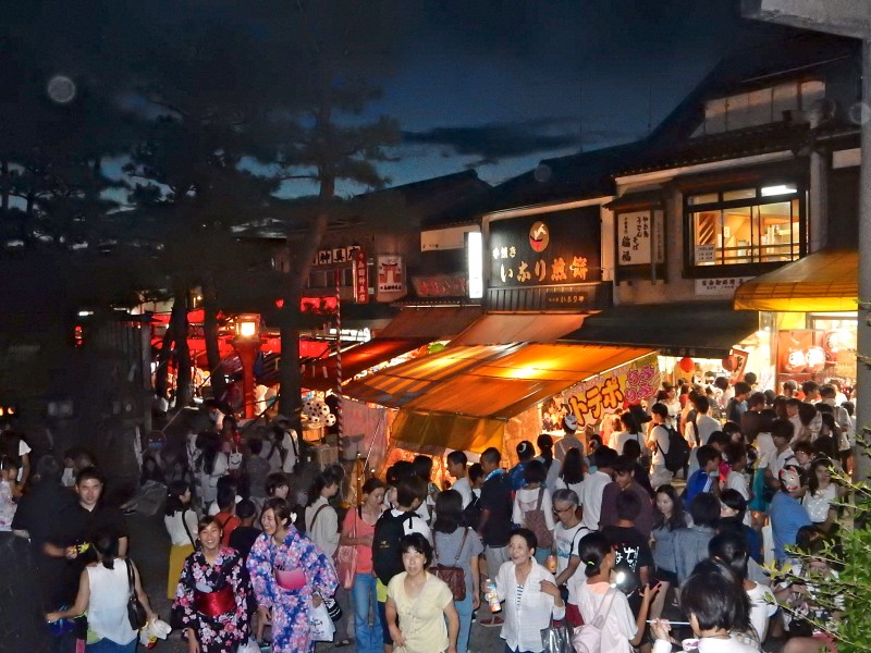 Jostling crowds squeeze past the stalls on the narrow approach road 