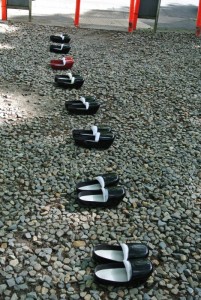 A pair of priest's shoes are placed on top of the coffin