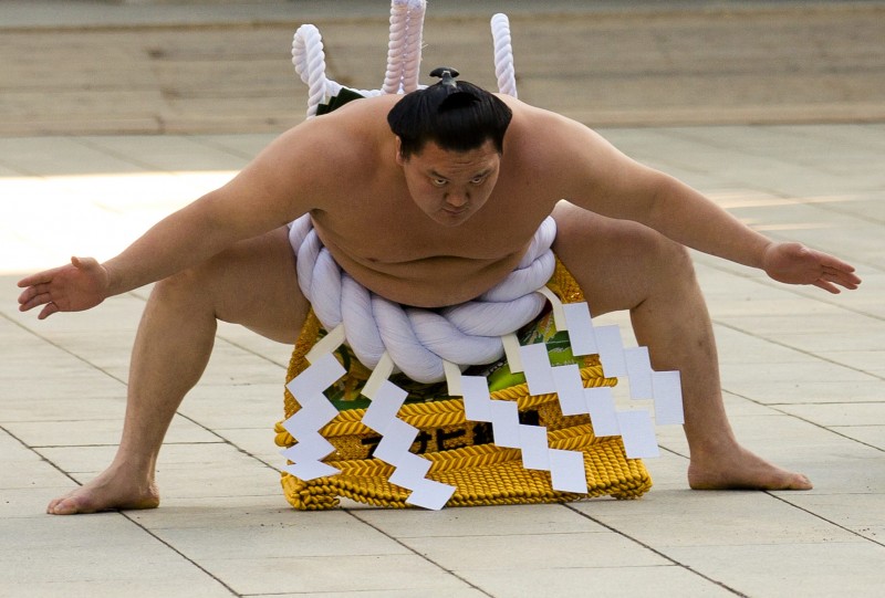 Mongolian-born grand sumo champion Yokozuna Hakuho performs the New Year's ring-entering rite Wednesday at the 2015 annual celebration for the New Year at Meiji Shrine in Tokyo. | REUTERS