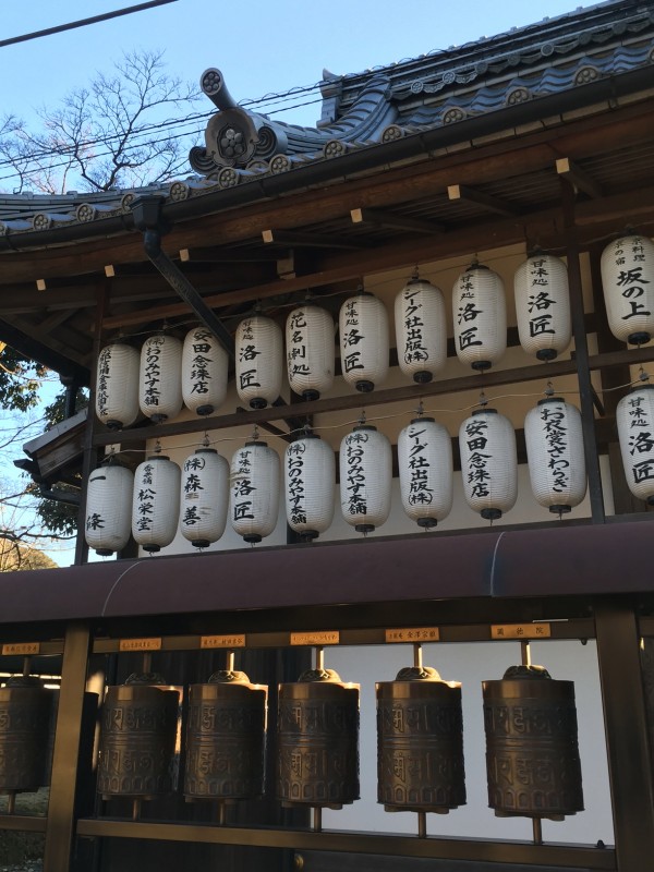 The side of the Tenjin Shrine has a decidedly Buddhist look, with Kodai-ji emblem on the roof tiles and prayer wheels along the side