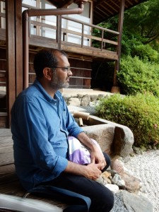 Pulitzer finalist, Sukuta Mehta, admires a garden... but are those clean lines, raked gravel and simple wooden buildings Zen or Shinto?